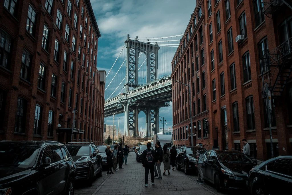 Manhattan bridge photographed from between two buildings