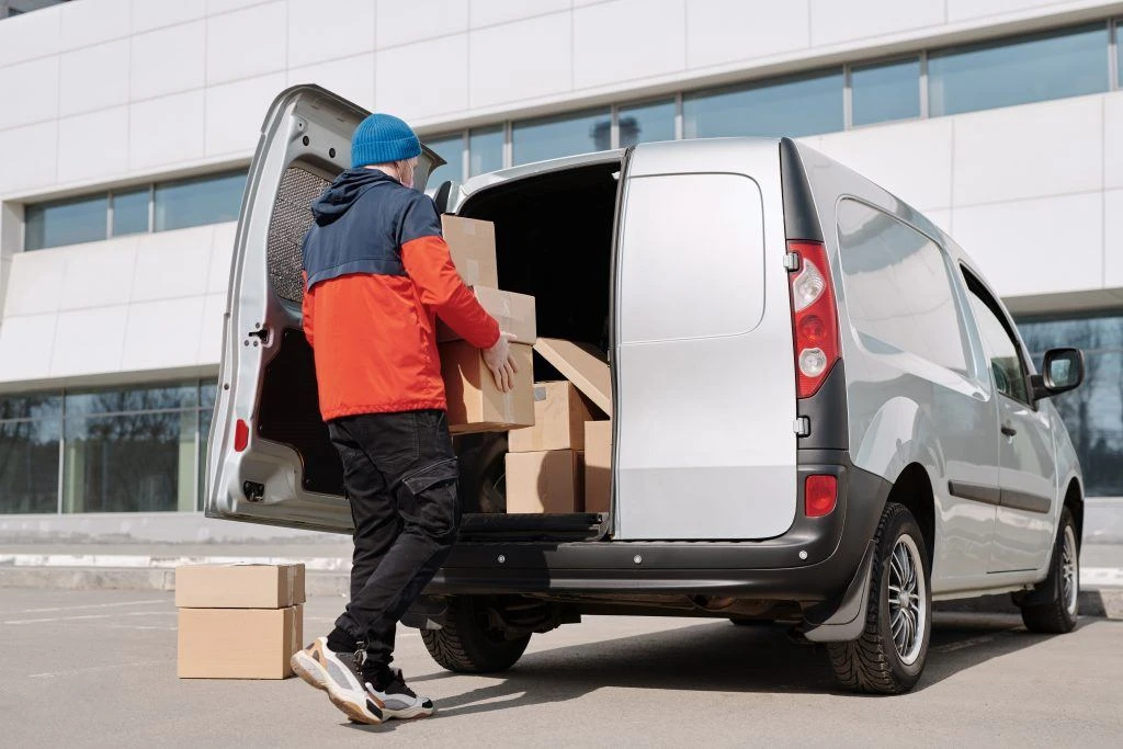 Man loading boxes into a white van