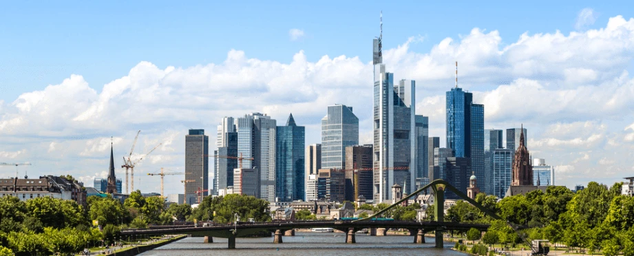 german skyline with many skyscrapers overlooking a bridge and river