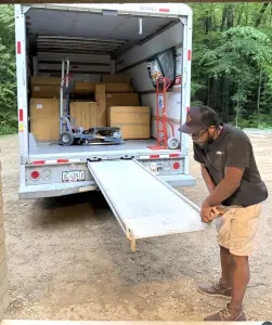 Mover carrying boxes during an international relocation from Thailand to Vermont